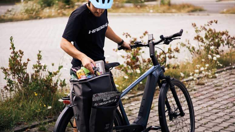 Ein Mann packt die Fahrradtasche